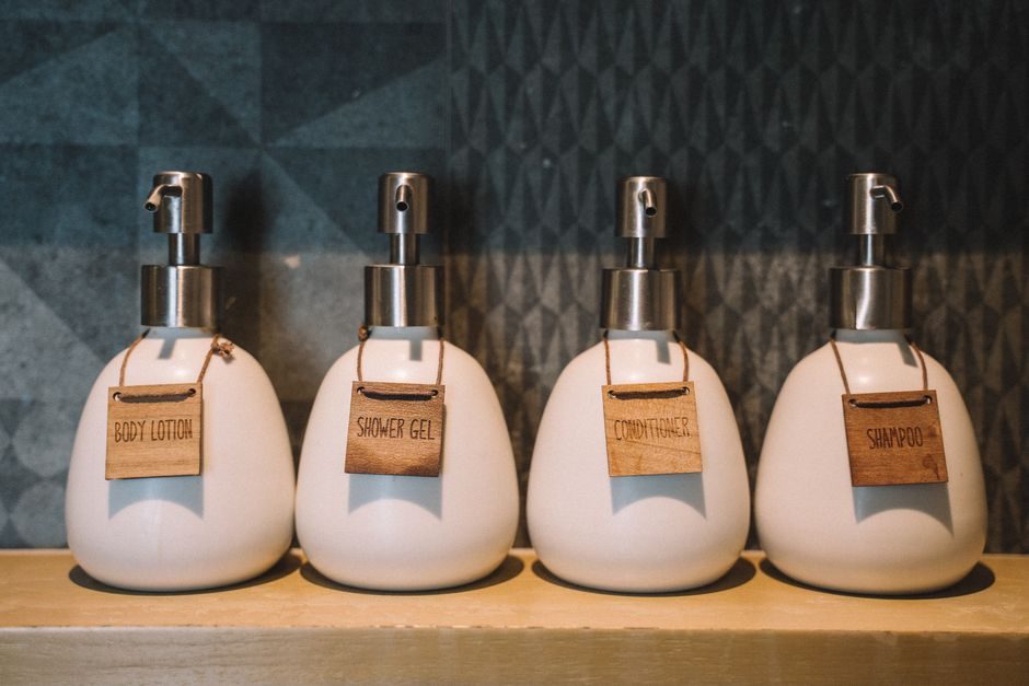 A row of pump bottles of bath and hair care products